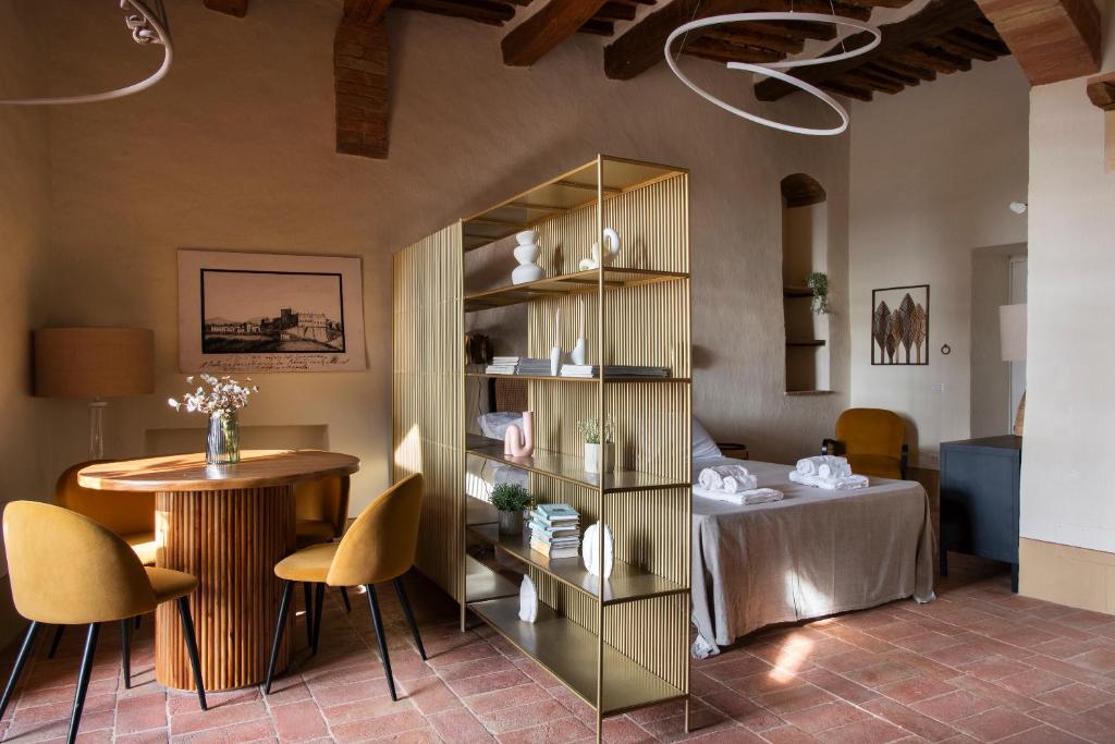a room with a bed and a book shelf at Il Borghetto - Oliviera loft in San Giovanni dʼAsso