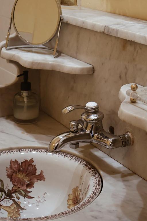 a bathroom sink with a mirror and a sink at Château Sainte Colombe in Saint-Geniès-des-Mourgues