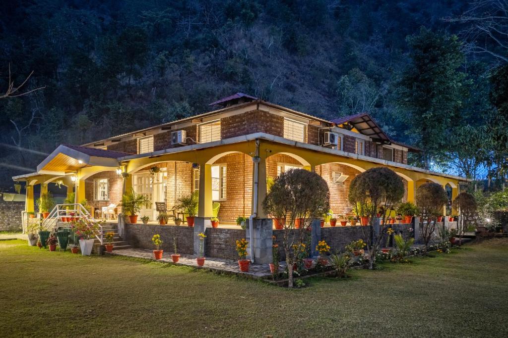 a large house is lit up at night at Alaya Stays Country Ville - 3 BHK Pet Friendly Villa with Lush Garden & Kids Room in Kokliyal Gaon