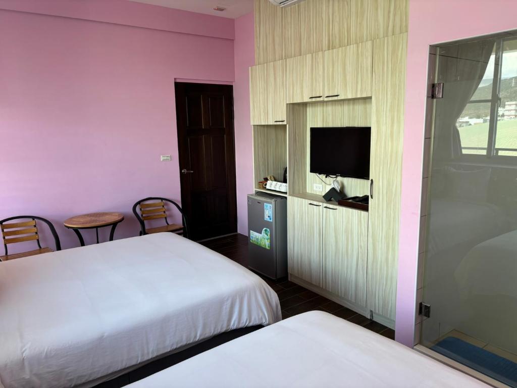 Rúm í herbergi á Ding Dong Homestay