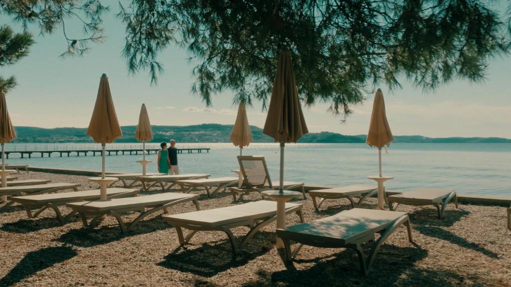 a group of chairs and umbrellas on a beach at Villas - Hotel & Resort Adria Ankaran in Ankaran