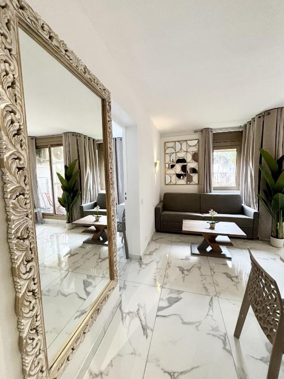 - un miroir dans le salon avec canapé dans l'établissement Residence Graziella Appartement 109, à Juan-les-Pins
