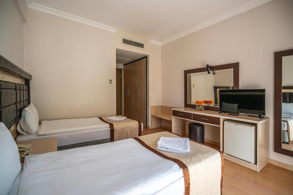 Postel nebo postele na pokoji v ubytování Tu Casa Gelidonya Hotel