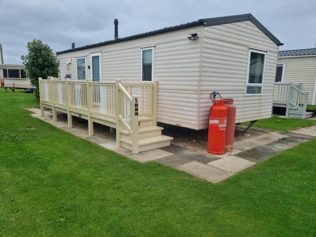 a house with a fire hydrant in front of it at S212 6 BERTH DELUXE GOLDEN PALM CHAPEL ST LEONARDs in Chapel Saint Leonards
