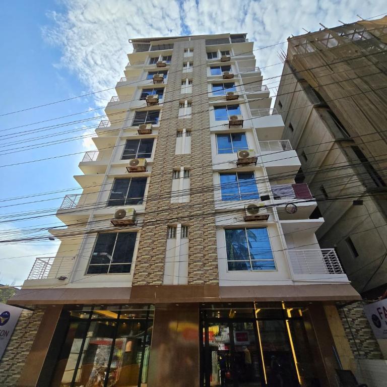 a tall building with windows on the side of it at Falcon Beach Resort in Cox's Bazar