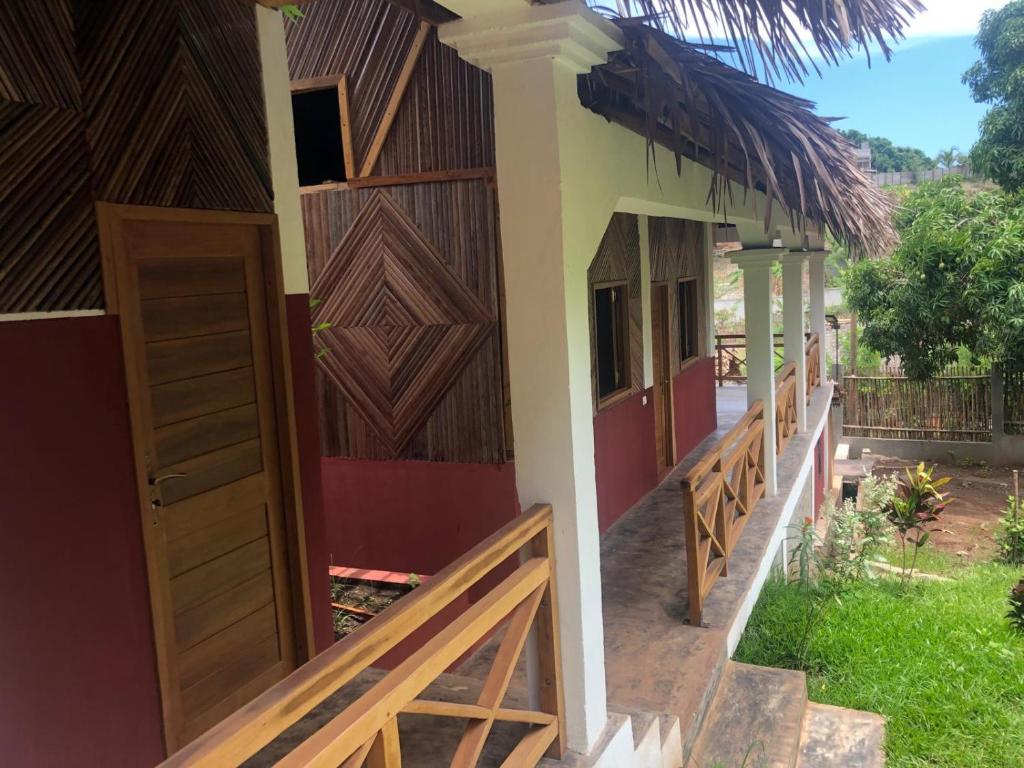 an entrance to a house with a barn door at STYLE MALGACHE et TOUT CONFORT in Nosy Be