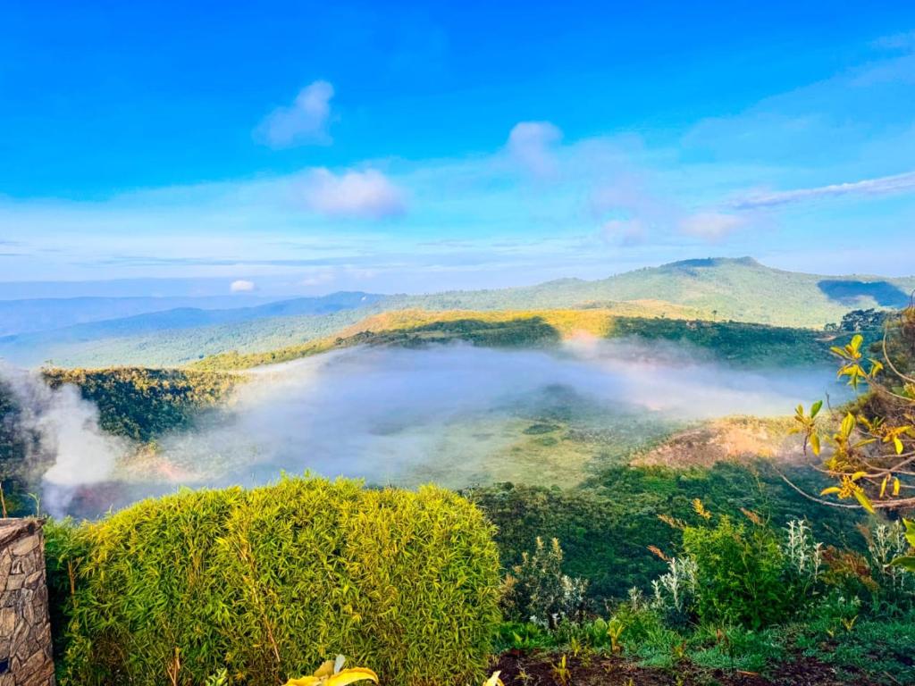 a view of a foggy valley with mountains in the background at Ol eburru cottage budget rooms in Gilgil