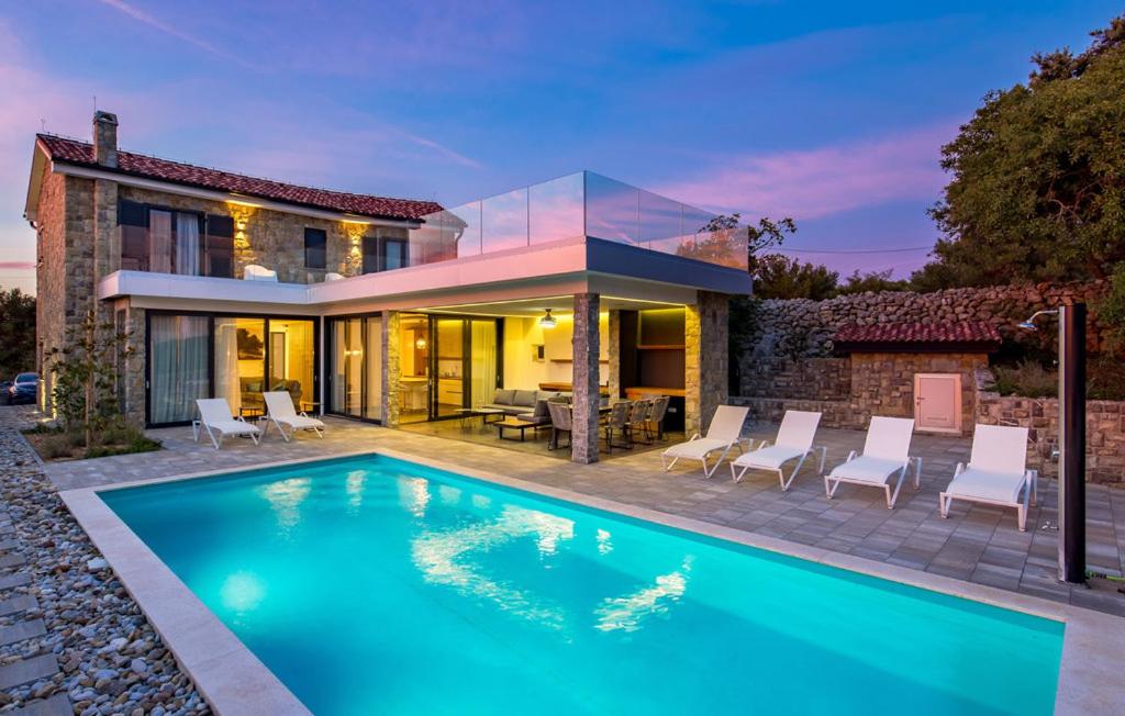 a swimming pool in front of a house at Charming Holiday Home with private heated pool in Jakišnica