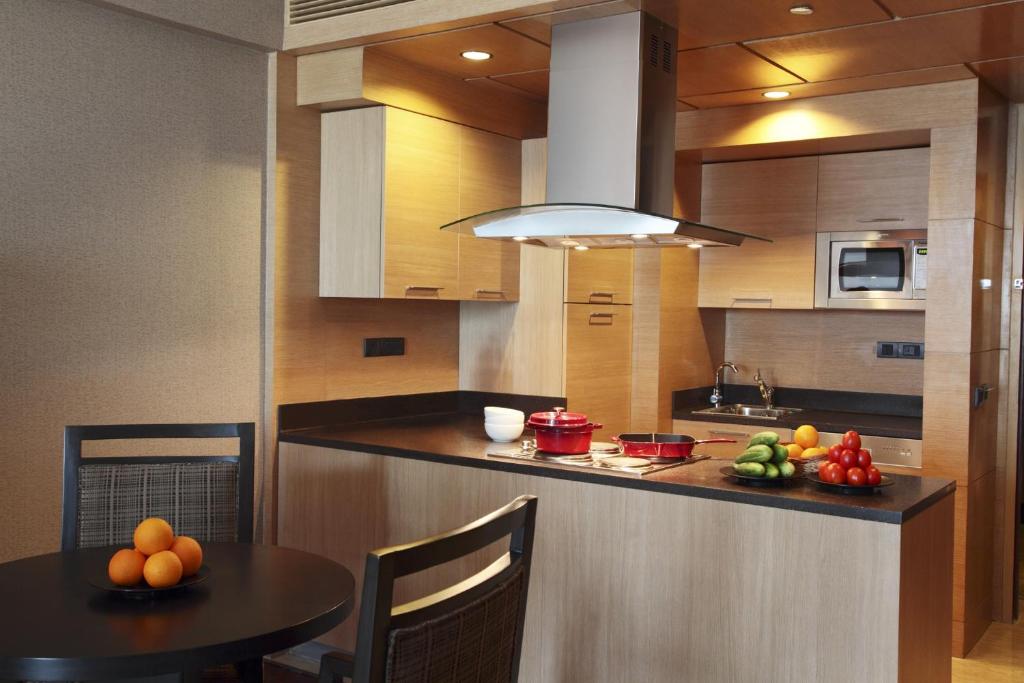 a kitchen with a table with fruit on it at The Leela Ambience Gurugram Hotel & Residences - The Luxury Urban Sanctuary in Gurgaon