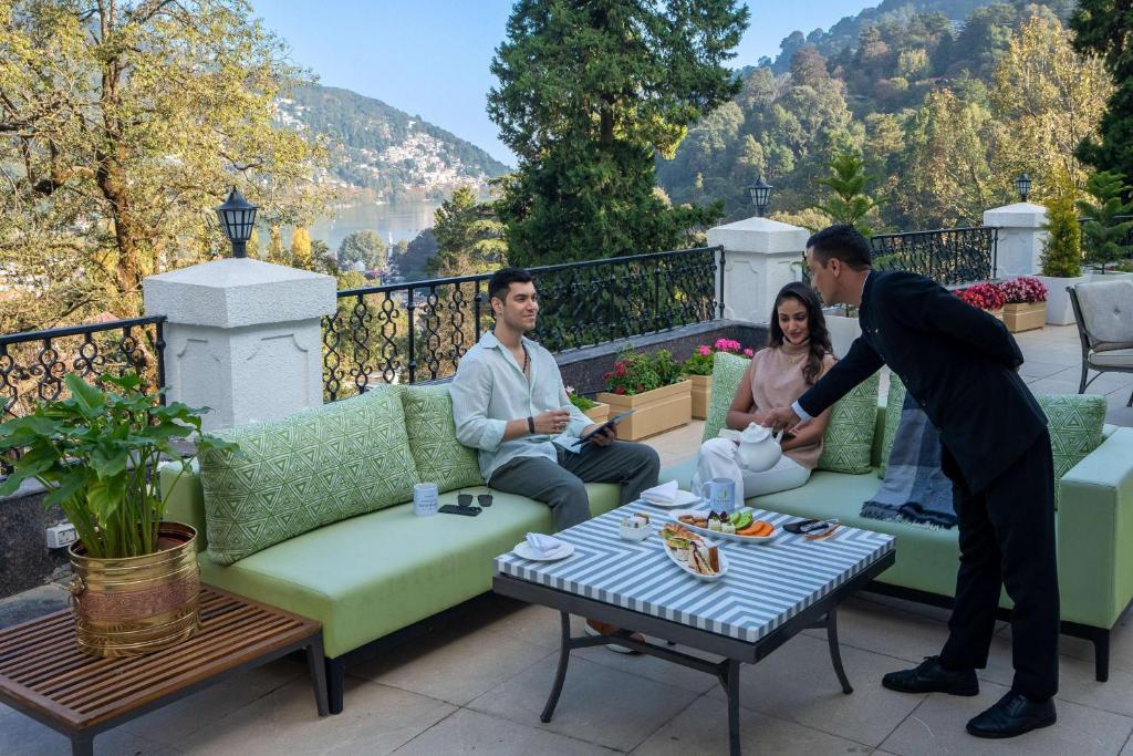a man and a woman sitting on a patio at Namah Nainital, a member of Radisson Individuals Retreats in Nainital