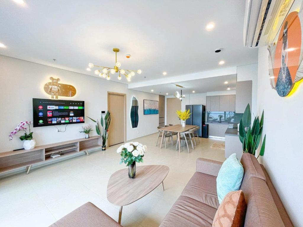 a living room with a couch and a table at Apartment Galaxy The Song Vung Tau Homestay in Vung Tau