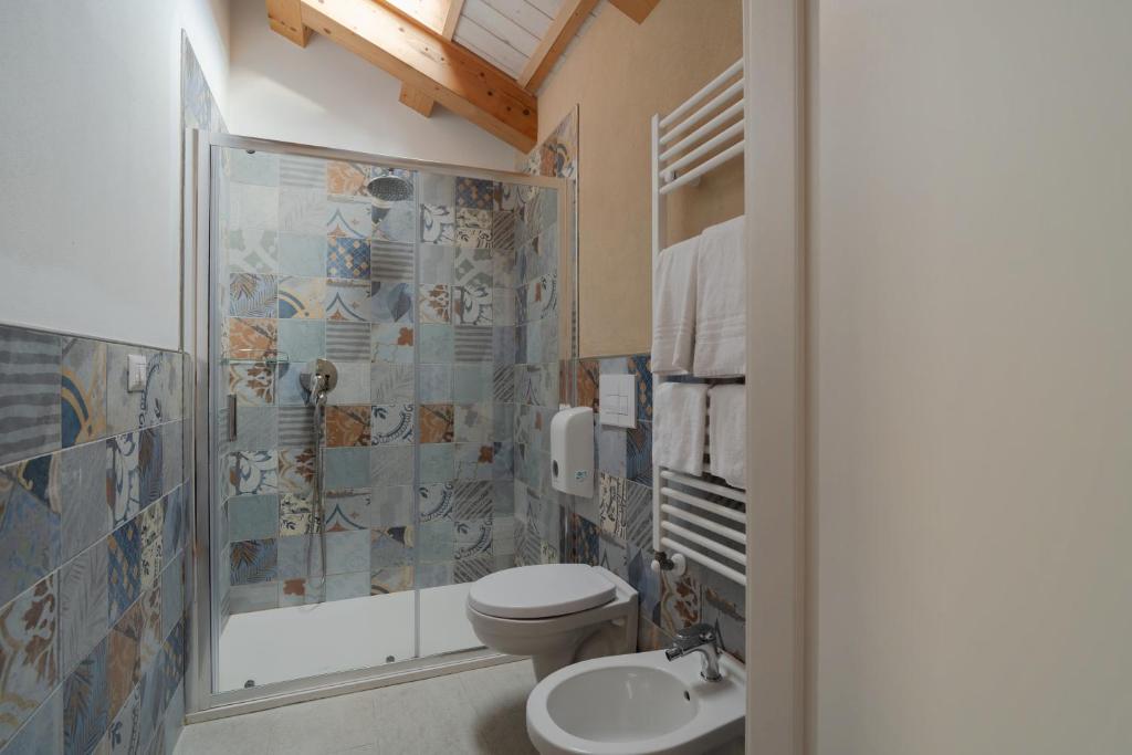 a bathroom with a toilet and a shower and a sink at FloVe' Rooms Venice in Venice