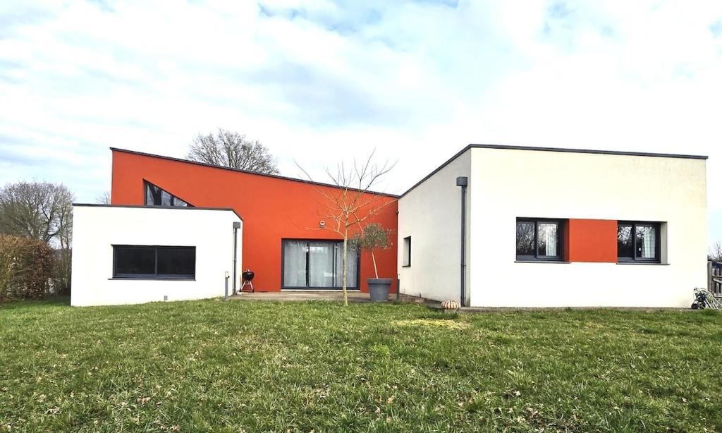 a white and orange house on a grass field at la belle de volnay in Volnay
