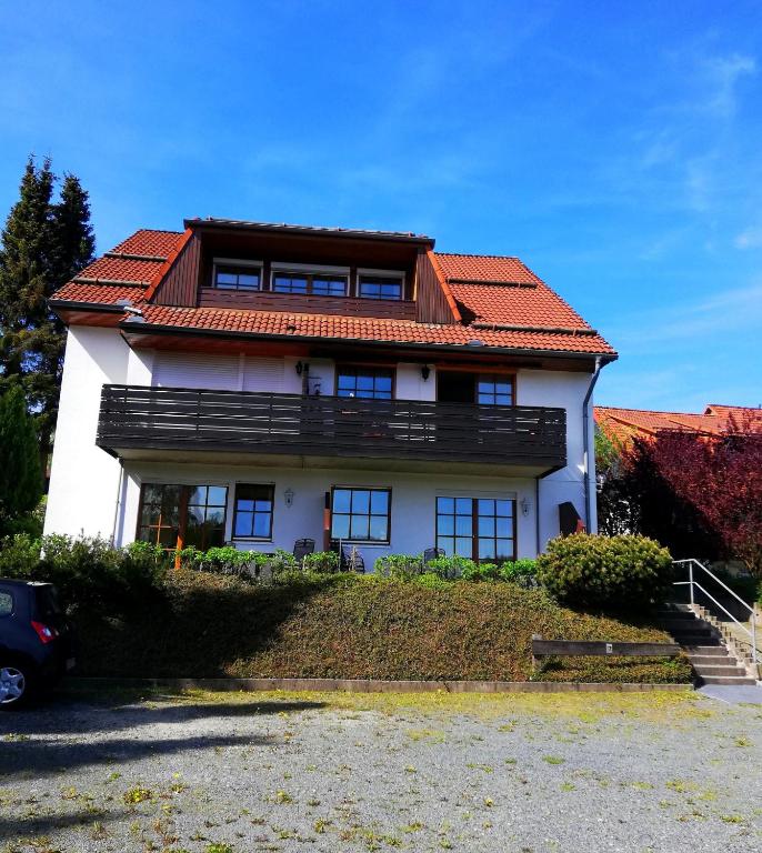 a large white house with a red roof at Harzwellness in Altenau