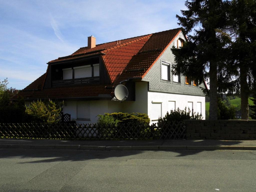 a white house with a red roof at Harzwellness in Altenau