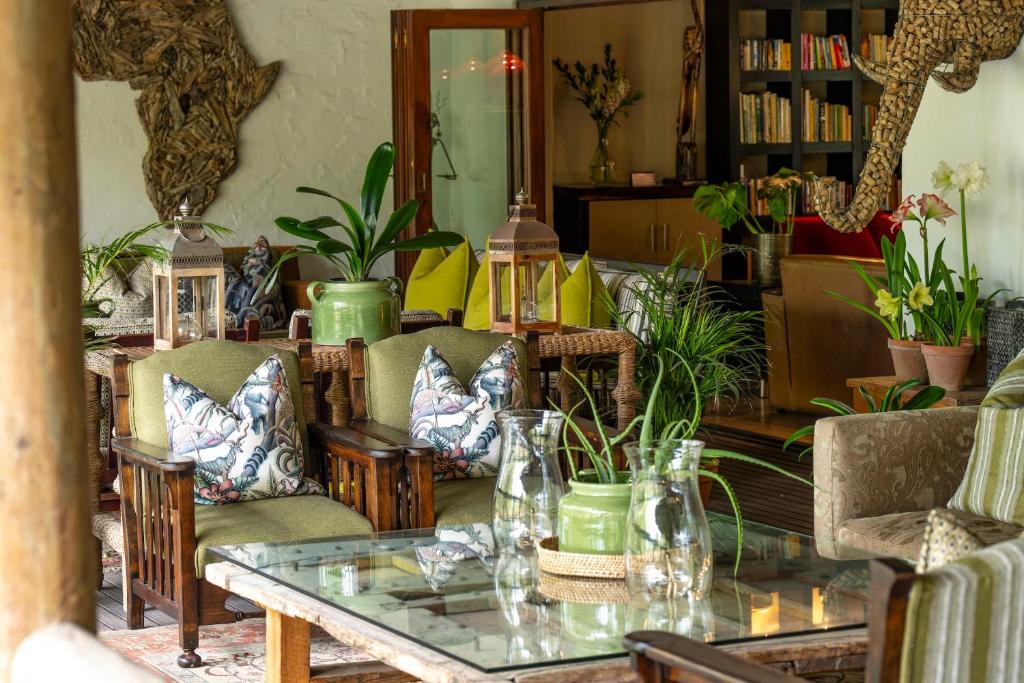 a living room filled with lots of plants at Woodall Country House and Spa in Addo