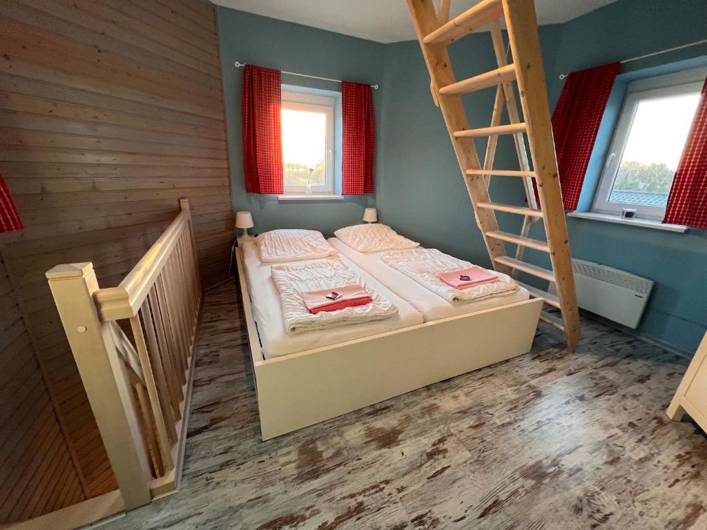 Postel nebo postele na pokoji v ubytování Ferienhaus Leuchtturm