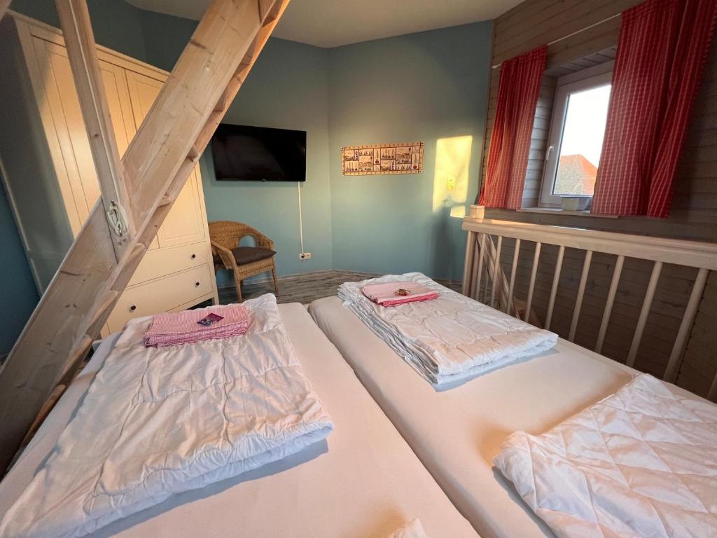 Postel nebo postele na pokoji v ubytování Ferienhaus Leuchtturm