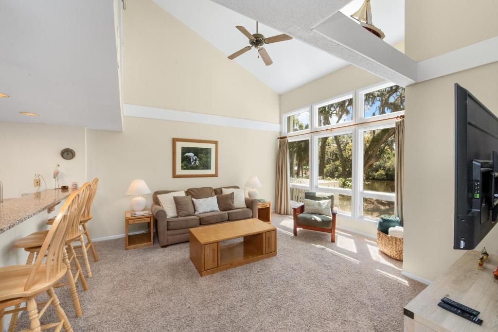 a living room with a couch and a table at Ocean State of Mind in Edisto Island