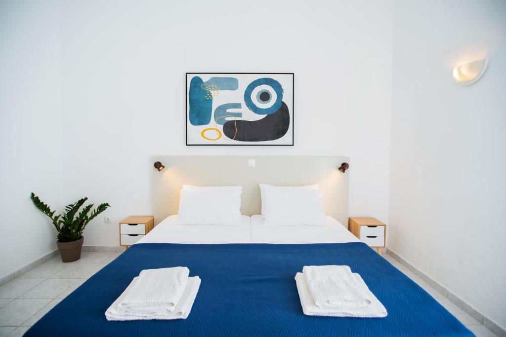 a bedroom with a large bed with towels on it at Seaside Suites in Kavos