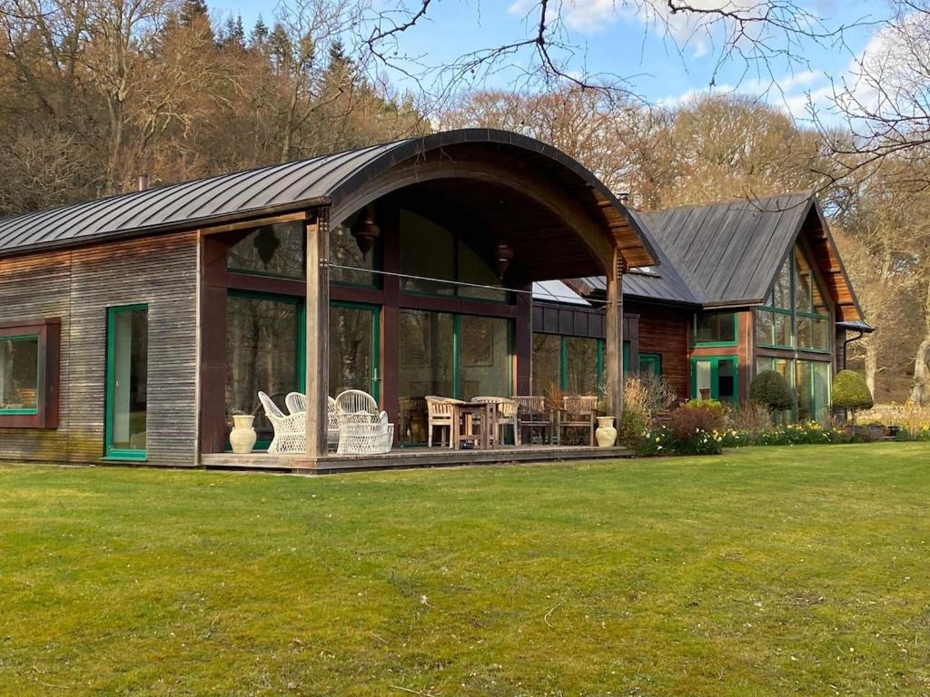 a large house with a large roof and windows at Spacious, cosy 6 bedroom house which sleeps 11 in Banchory