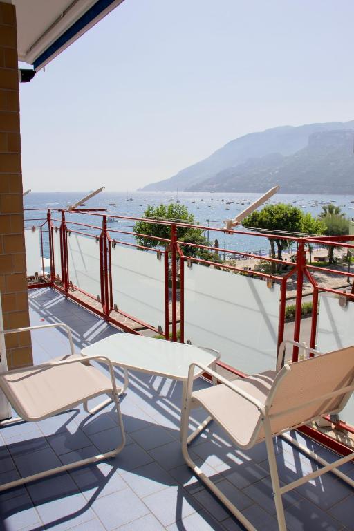 a pair of chairs on a balcony overlooking the ocean at Blumare Amalfi Coast in Maiori