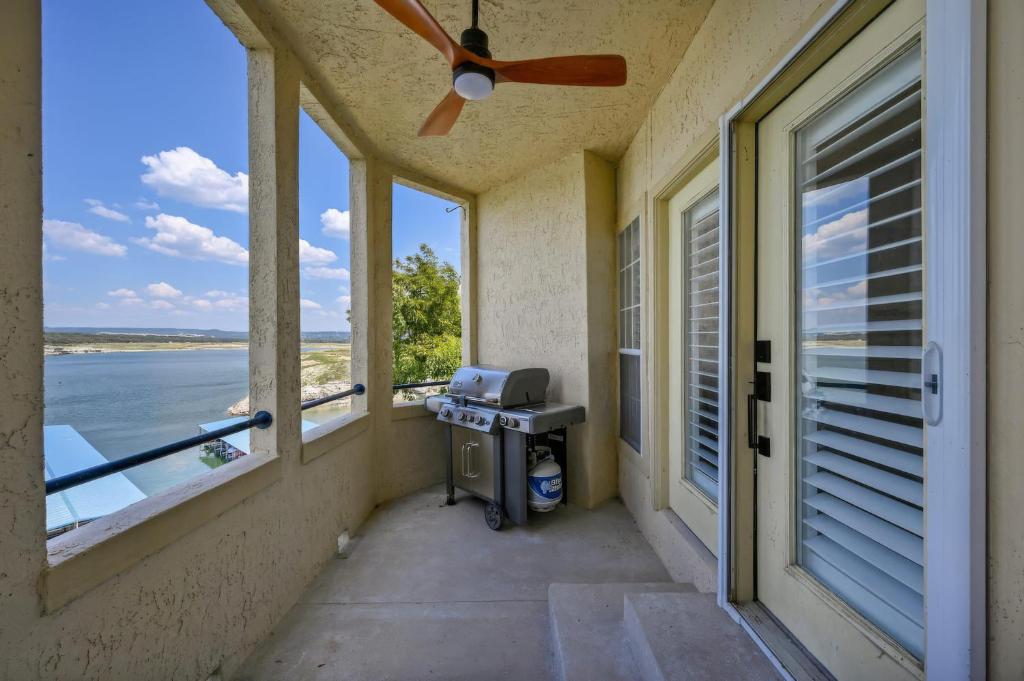 a porch with windows and a ceiling fan at Island Summer Sunrises Spa Eats Last Minute Deals! in Lago Vista