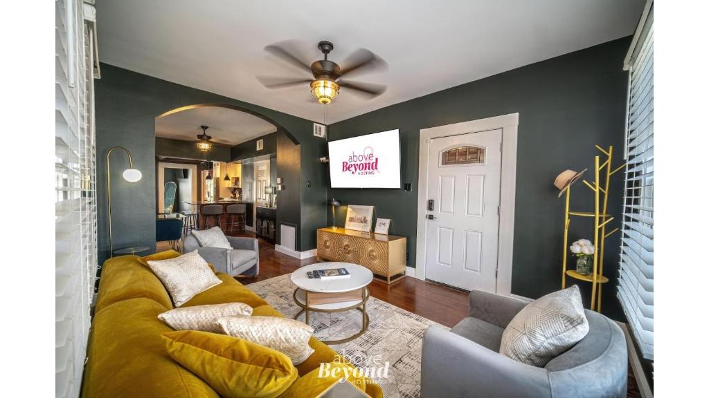 a living room with a couch and a ceiling fan at The Royal Treatment Downtown, Great for Travels in San Antonio