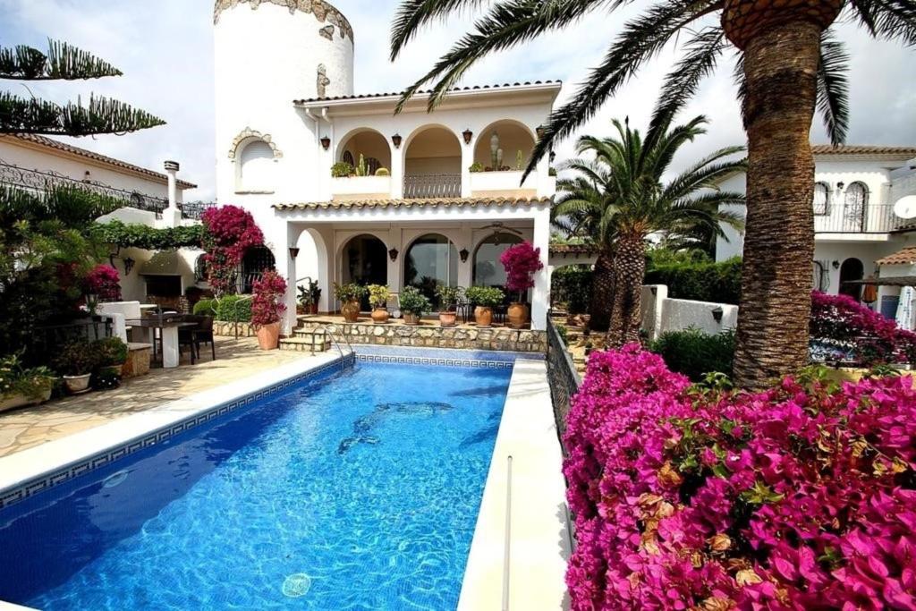 a villa with a swimming pool in front of a house at Casa BOWA in Hospitalet de l'Infant