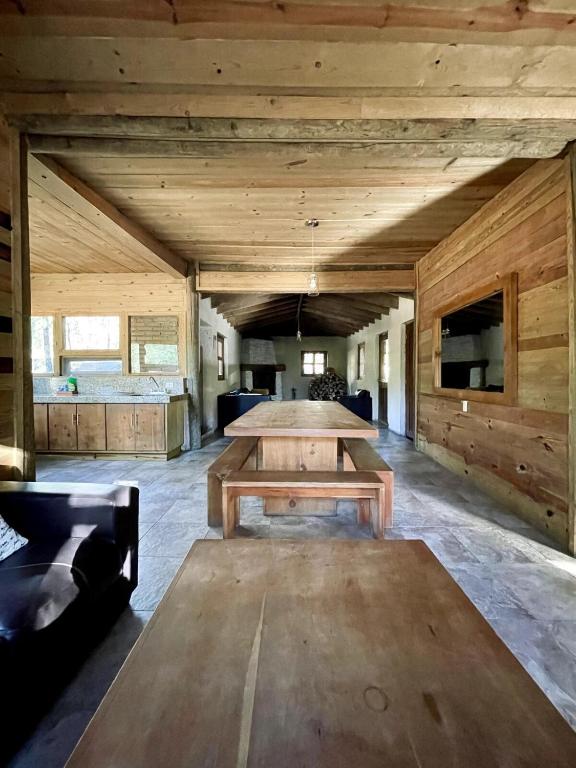 a large room with a table and a couch at Torre de Carpio, Cabaña Molitor in San Isidro