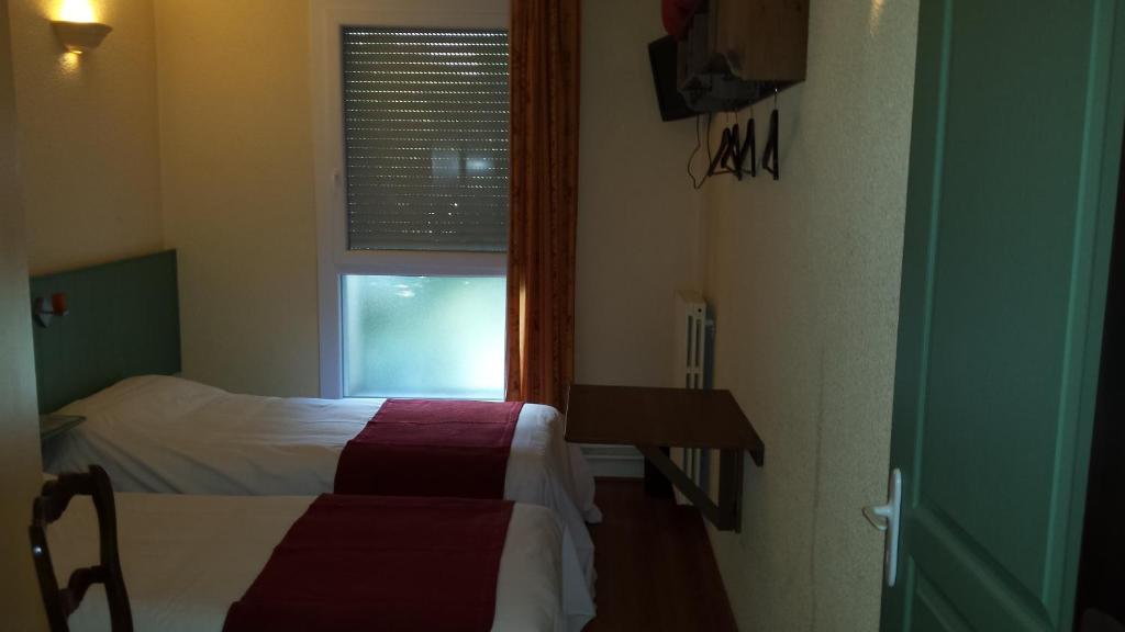 Postel nebo postele na pokoji v ubytování Hostellerie Le Mirabeau