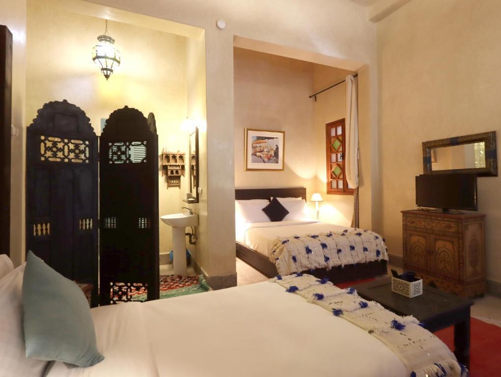 Postel nebo postele na pokoji v ubytování Riad Villa Elgada