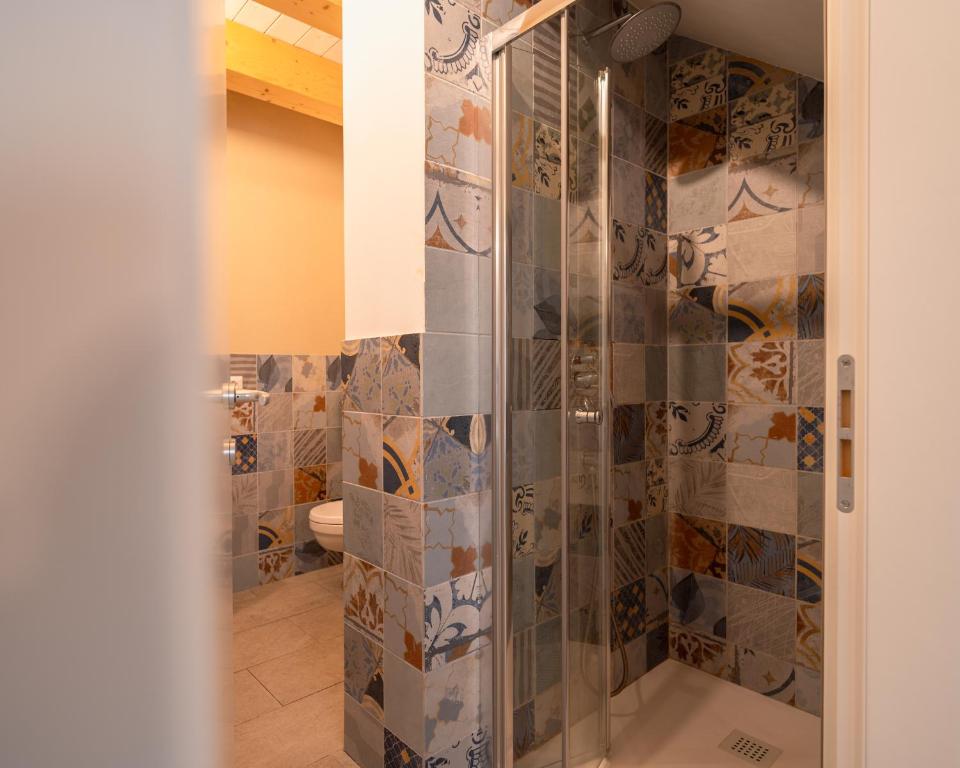 a bathroom with a shower with a glass door at FloVe' Rooms Venice in Venice