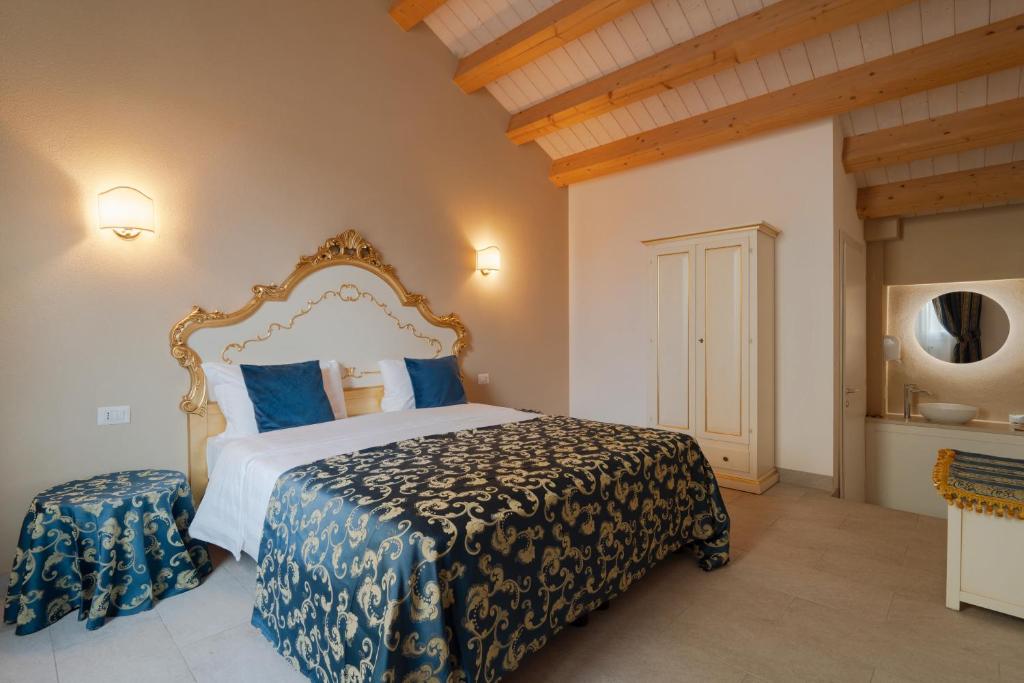a bedroom with a large bed with blue pillows at FloVe' Rooms Venice in Venice