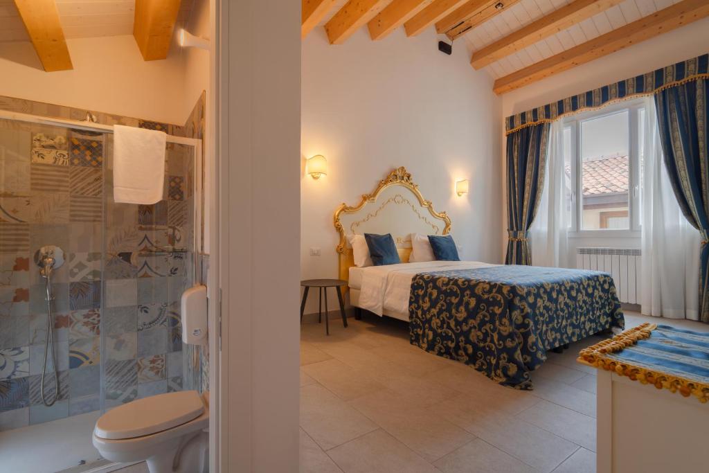a bedroom with a king sized bed and a shower at FloVe' Rooms Venice in Venice