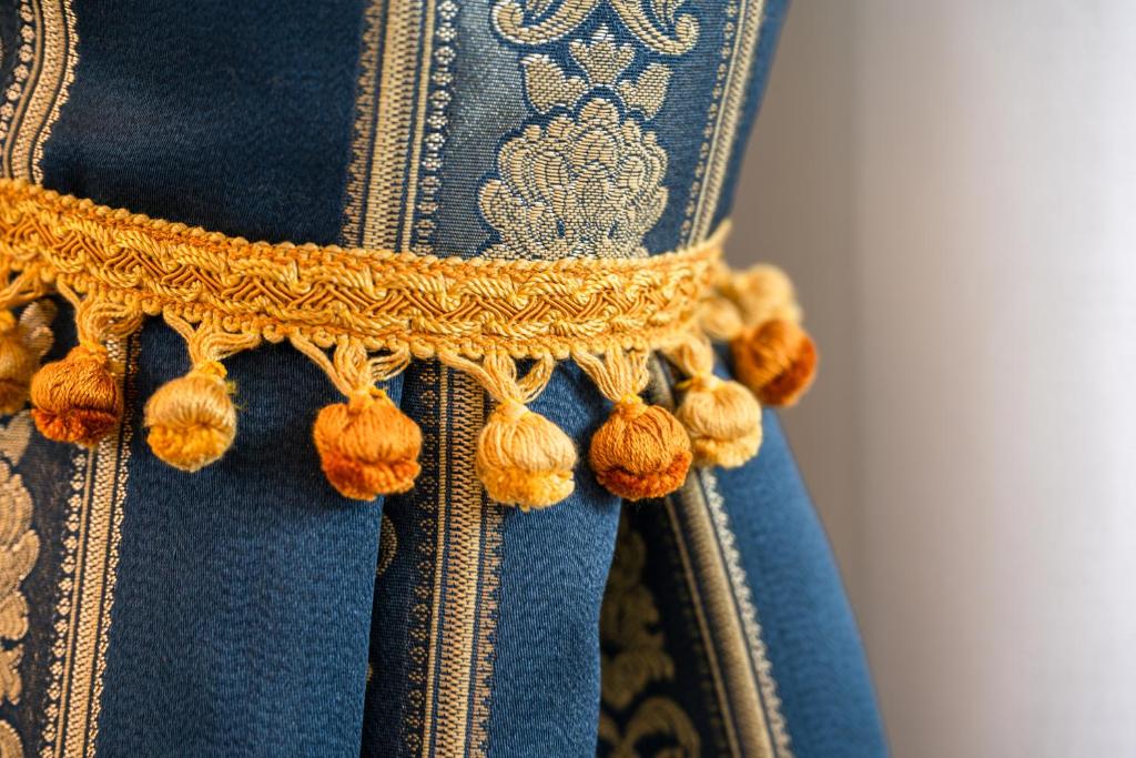 a close up of a blue dress with a gold trim at FloVe' Rooms Venice in Venice