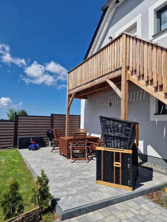 a patio with a deck and a table and chairs at Ferienwohnung LOUISE in Dreschvitz
