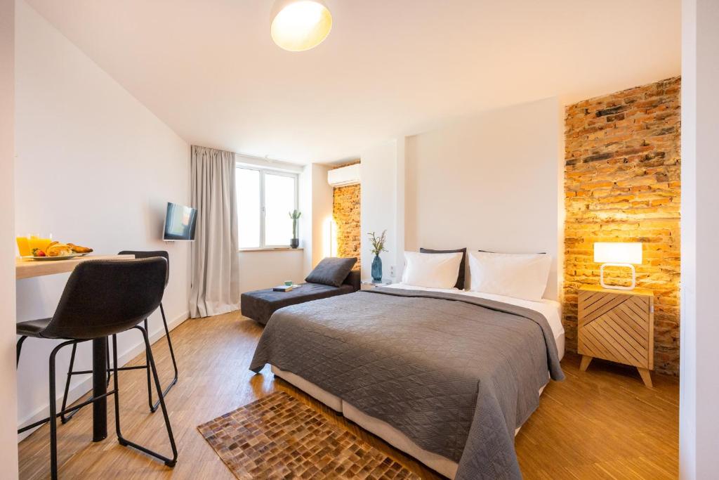 a bedroom with a bed and a desk with a chair at Apartment Musala N 01 in Varna City