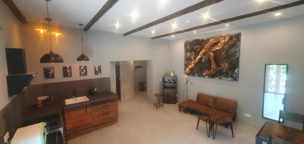 a living room with a couch and a painting on the wall at Kastaniennest in Bingerbrück