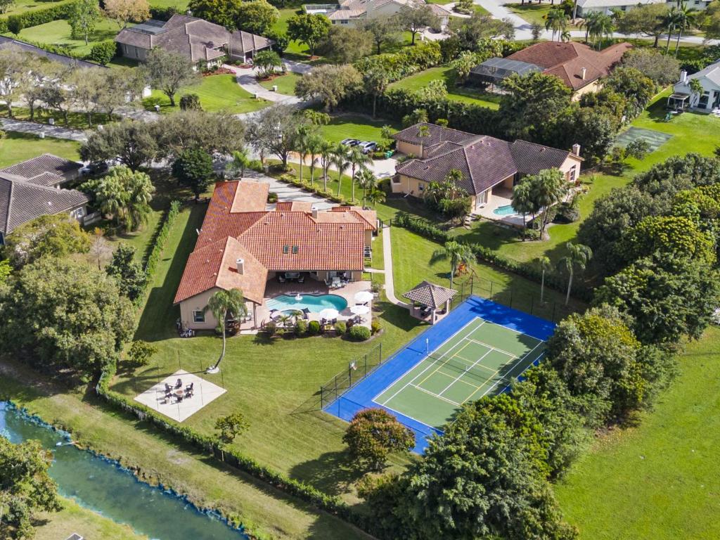 an aerial view of a house with a tennis court at Grand 6BR Plantation Estate w Tennis POOL in Sunrise