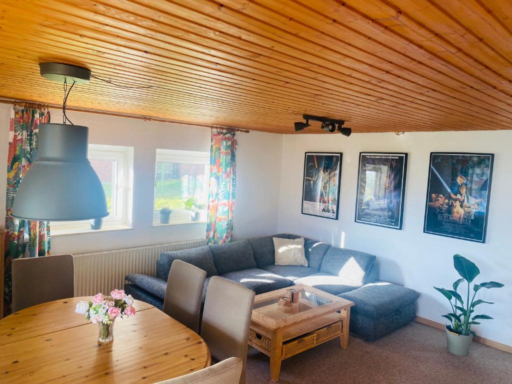 a living room with a couch and a table at Ferienwohnung Stargardt in Bad Münder 6 Personen Soutterain in Bad Münder am Deister