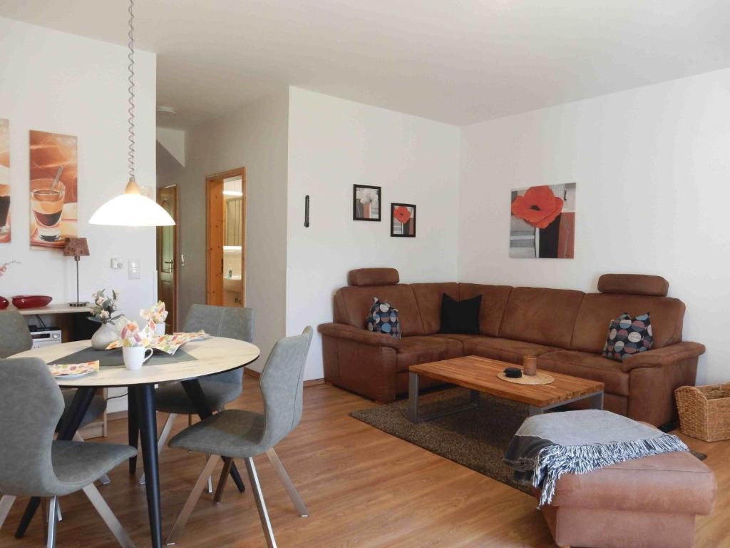 a living room with a couch and a table at Hinter den Dünen D82 in Prerow
