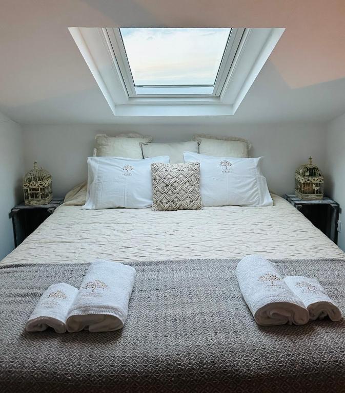 a bedroom with a bed with two towels on it at Casas da Pereira in Barcos