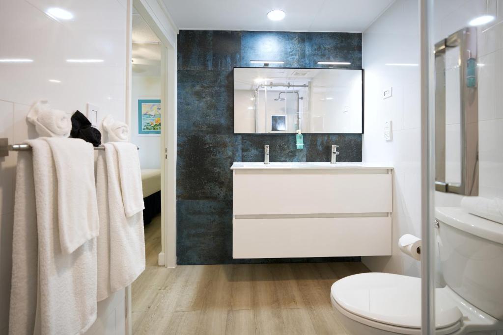 a white bathroom with a sink and a toilet at La Vista Resort in Simpson Bay