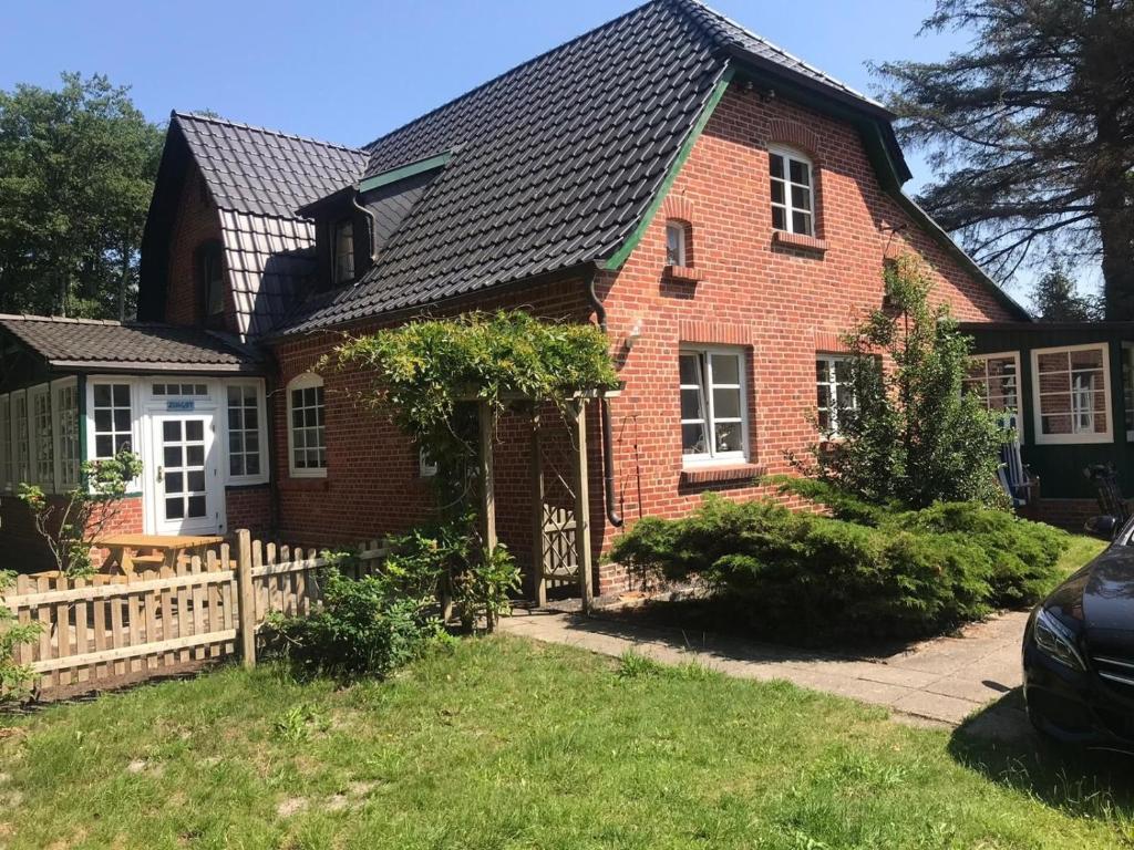 a red brick house with a black roof at "Ahrenshoop" in Prerow