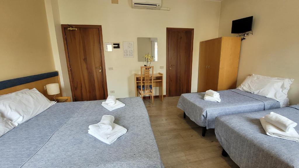 Postel nebo postele na pokoji v ubytování Hotel Montepiana