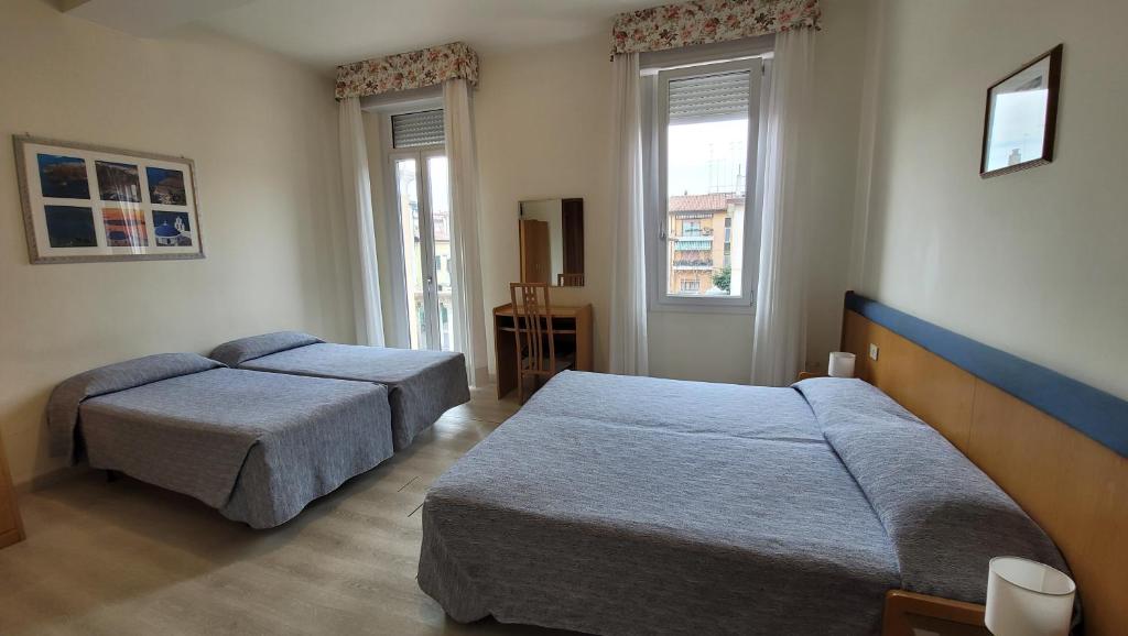 Postel nebo postele na pokoji v ubytování Hotel Montepiana