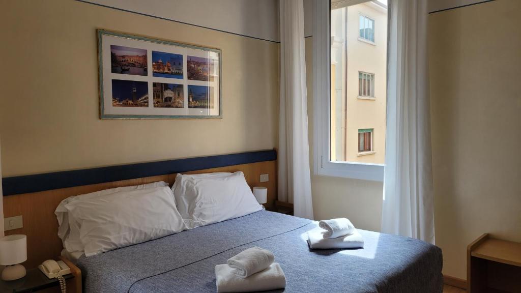 Postel nebo postele na pokoji v ubytování Hotel Montepiana