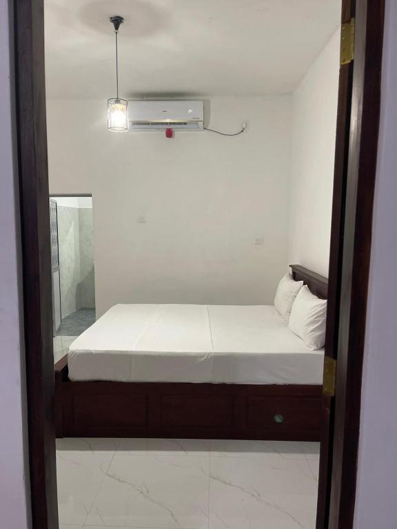 Postel nebo postele na pokoji v ubytování Golden Paradise Transit Hotel
