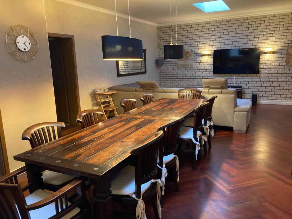 a dining room with a large wooden table and chairs at Ferienhaus am Mühlenberg in Waren